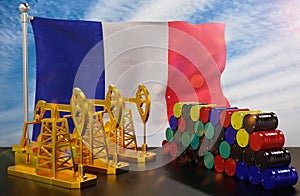 The France's petroleum market. Oil pump made of gold and barrels of metal. The concept of oil production.