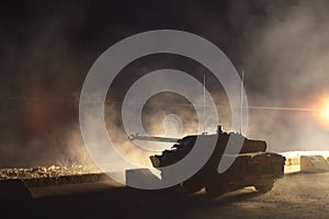 France, the training center of a foreign legion - circa, 2011. AMX-10 tank during night training firing.