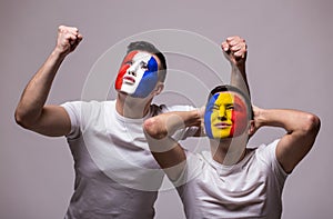 France vs Romania on white background. Football fans of Romania and France national teams demonstrate emotions