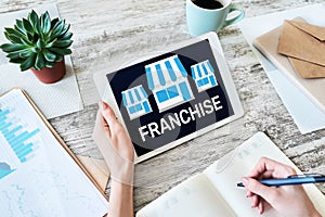 Franchise business model and growth concept on device screen.