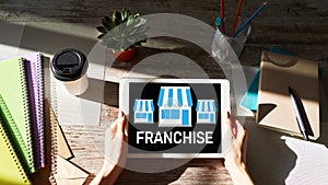 Franchise business model and growth concept on device screen.