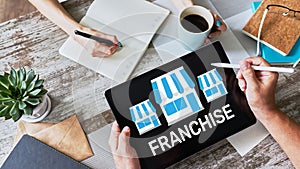 Franchise business model and growth concept on device screen.