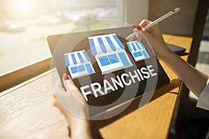 Franchise business model and growth concept on device screen.