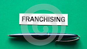 FRANCHISING - word on a green background with a black handle