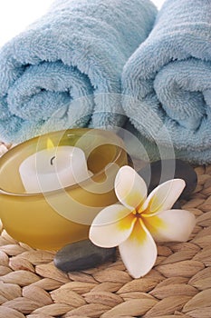 Frangipani,candle and towel on mat