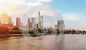 Frankfurt city skyline at evening time front of Main river in Germany