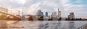 Frankfurt city skyline at evening time front of Main river in Germany