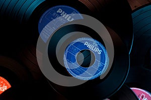 Frankfurt, Germany - April 2021: close-up of black vinyl record of Philips recording studio, color lighting, analog retro music