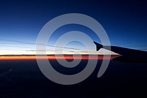 FRANKFURT, GERMANY - JAN 20th, 2017: View on the sunset, germany during winter and airplane wing from the inside the