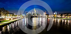 Frankfurt, Germany skyline at night beyond the river