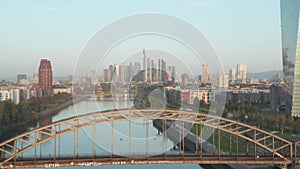 Frankfurt am Main, Germany Skyscraper Skyline View slow Dolly out revealing Bridge over Main River at Sunrise, Aerial