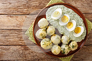 Frankfurt traditional dish of potatoes, boiled eggs and the famous green sauce close-up on a plate. horizontal top view
