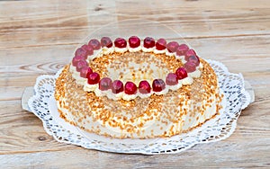 Frankfurter Kranz with cherries on rustic wood