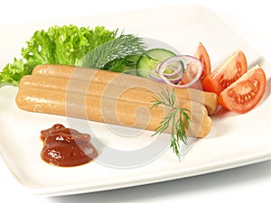 Frankfurters with ketchup and vegetables photo