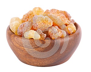 Frankincense resin in wooden bowl, isolated on white background. Pile of natural frankincense Olibanum. Incense.