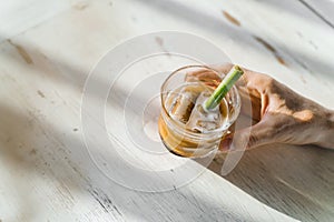 Frapuccino in a cafe in Bali. Cold coffee drink with an organic straw.