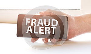 fraud alert on display in hands on white background