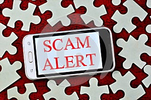 Fraud alert-a message on the smartphone screen. Fraud is the theft or acquisition of the right to someone else`s property by