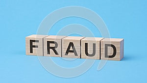 fraud word made with building blocks on a light background