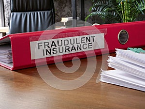 Fraudulent insurance documents on the desk.