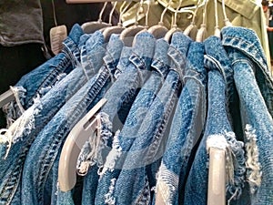 Frayed denim jacket jeans hang in store shop