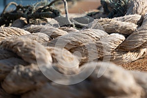 Frayed mooring ropes on fishing dock in Portugal.