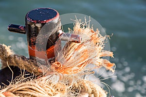 Frayed Rope on Rusty Cleat