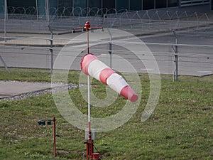 Frayed windsock in moderate wind against blue sky