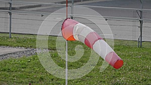 Frayed windsock in moderate wind on the airfield