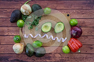 Frazzled face with halved avocado, fresh cilantro, and guacamole ingredients