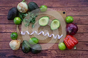 Frazzled face with halved avocado, fresh cilantro, and guacamole ingredients