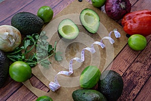 Frazzled face with halved avocado, fresh cilantro, and guacamole ingredients