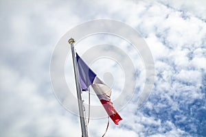 Frazzled flag of France waving in the wind