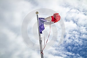 Frazzled flag of France waving in the wind