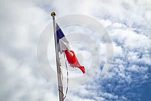 Frazzled flag of France waving in the wind