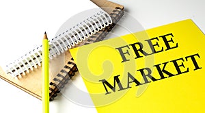 FRE MARKET text written on a yellow paper with notebook