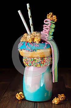 Freak shake topping with donut, popcorn and rainbow marmalade on