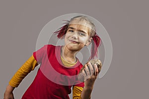 Freakish kid holds misshapen wrong color fruits and vegetables, waste food concept