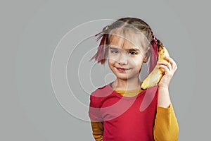 Freakish kid holds misshapen wrong color fruits and vegetables, waste food concept