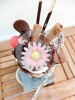 Freakshake, a kind of gourmet Milkshake with topping : donut, whipped cream, chocolate ball, wafer biscuits, candy, mikado, mini i