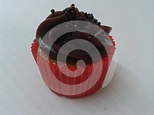 Freash baked cupcakes with dark chocolate frosting photo