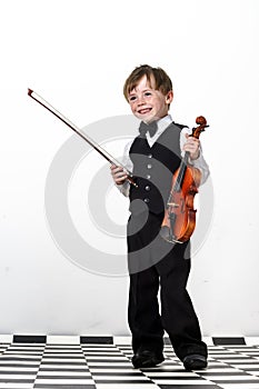 Freckled red-hair boy playing violin.