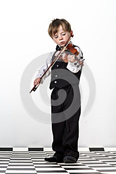 Freckled red-hair boy playing violin.