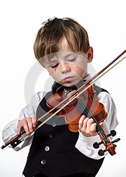 Freckled red-hair boy playing violin.