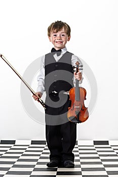 Freckled red-hair boy playing violin.