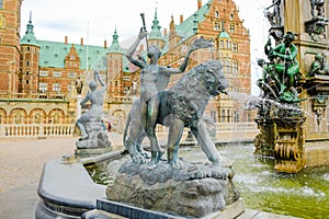 Frederiksborg castle or palace: The Angel and the Lion, fragment of the Neptune fountain on the castle`s forecourt