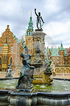 Frederiksborg castle or palace: Neptune Fountain on the castle`s forecourt. Hillerod, Denmark