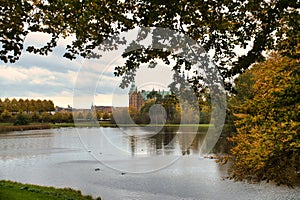 Frederiksborg Castle Park in autumn with mighty deciduous, landscaped lake