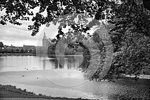 Frederiksborg castle park in black and white, with created lake, in the background the castle