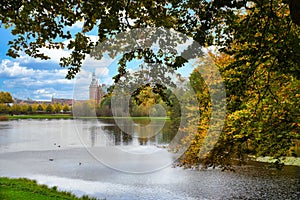 Frederiksborg castle park with created lake, in the background the castle. Colors